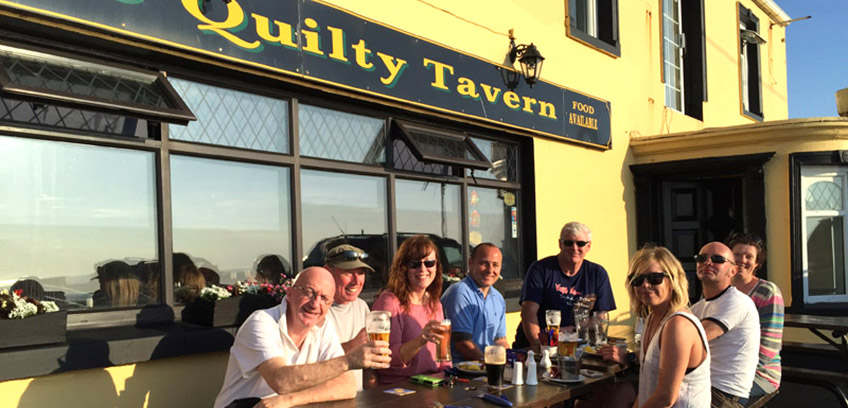 Apres dive pints outside the Quilty Tavern